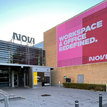 The entrance to NOVI in Aalborg, with a large banner reading Workspace & office redefined